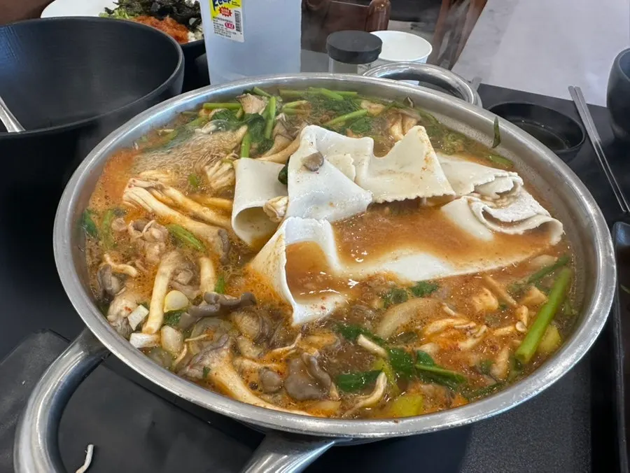 Cooked shabu meat lifted out of the pot