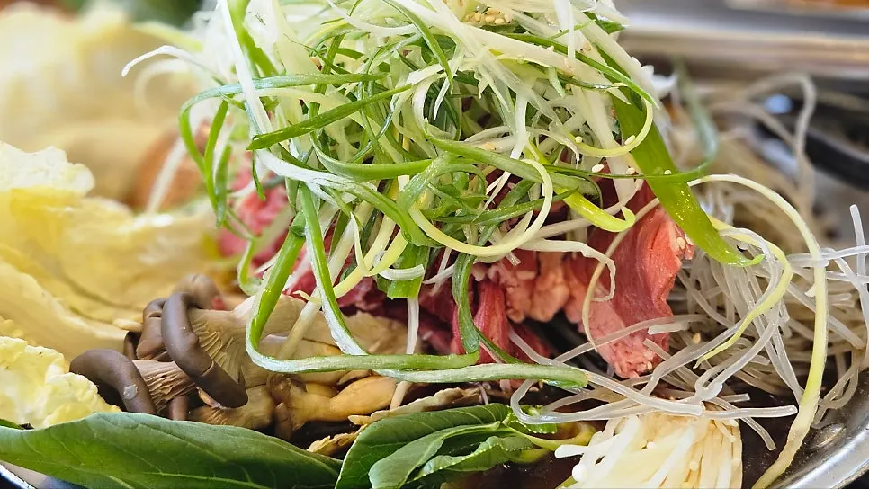 A full spread of fire-grilled octopus and pork with hot pot