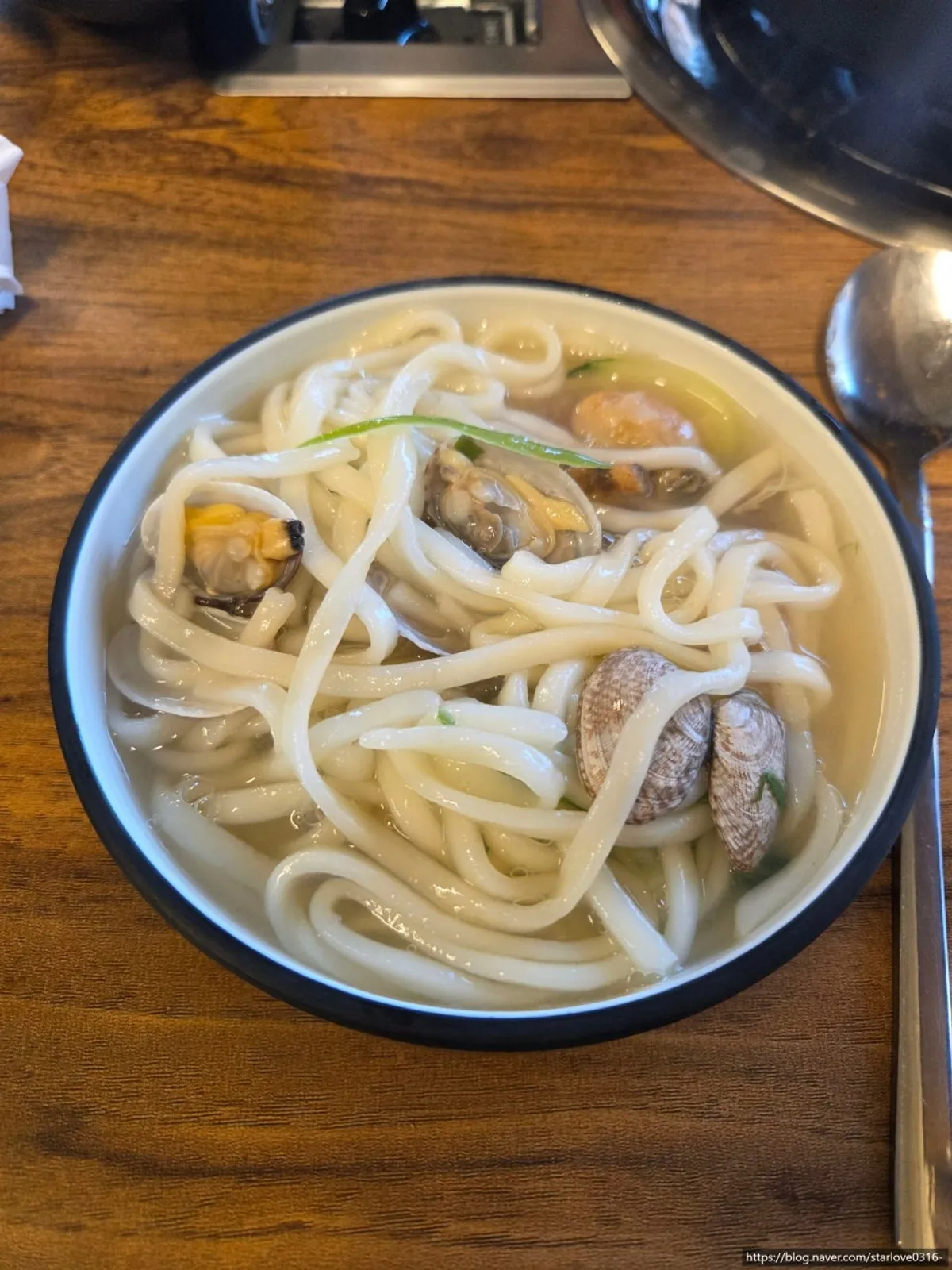 A bowl of seafood kalguksu made with pufferfish broth
