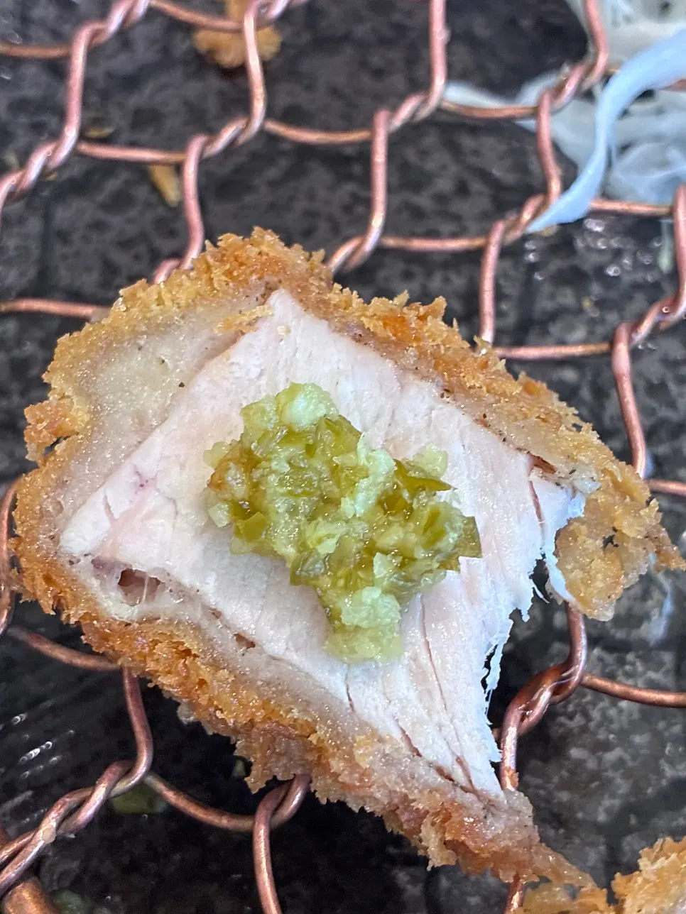 A piece of tonkatsu topped with lemon kosho