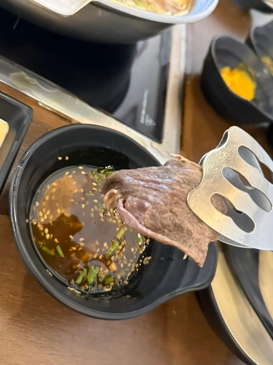 Small dishes of chili sauce and peanut sauce