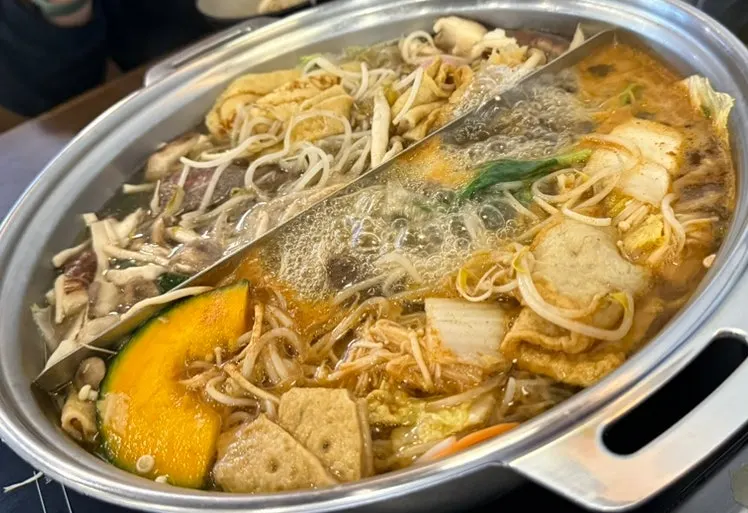 Shabu toppings including fish cake, squash, rice cake sticks and shrimp