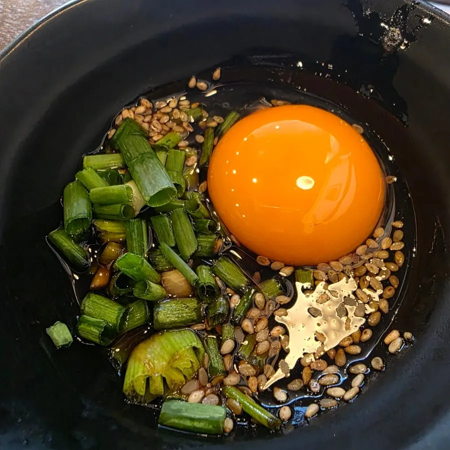 Homemade tare sauce topped with egg yolk
