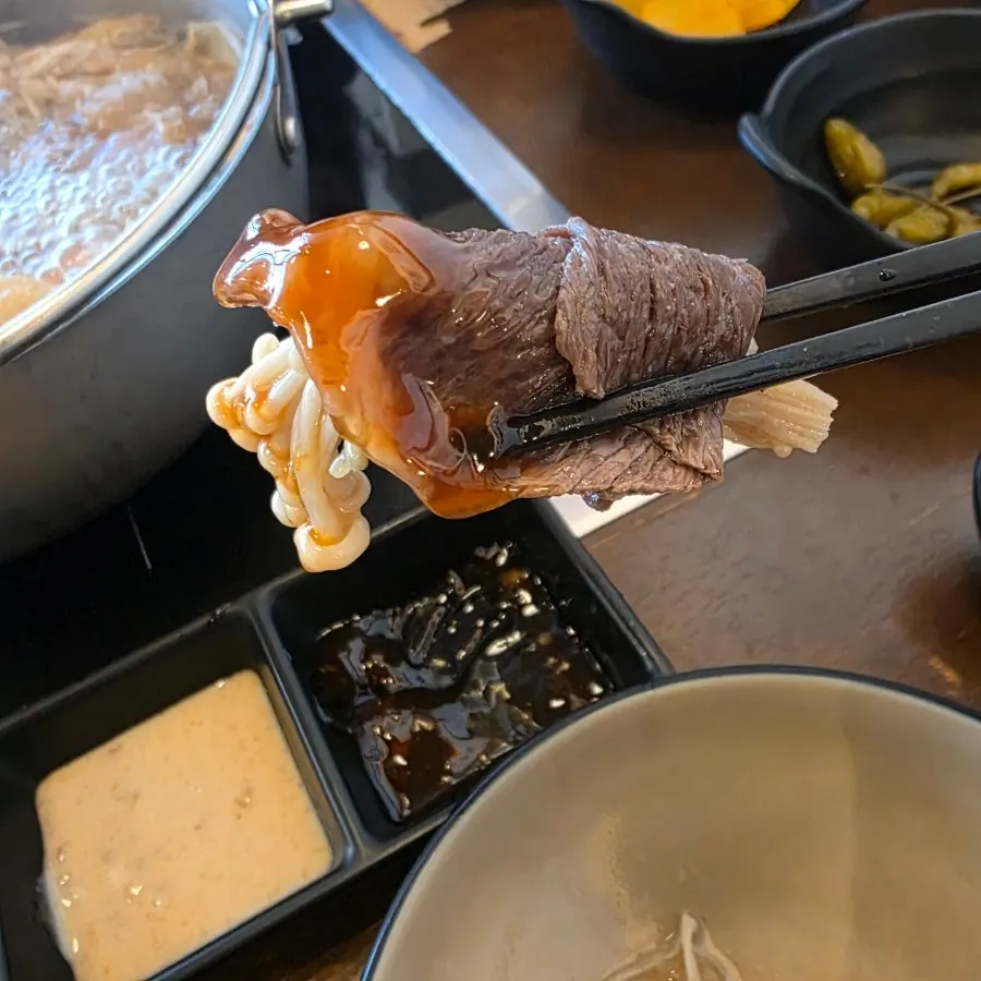A bite of shabu-shabu with sauce