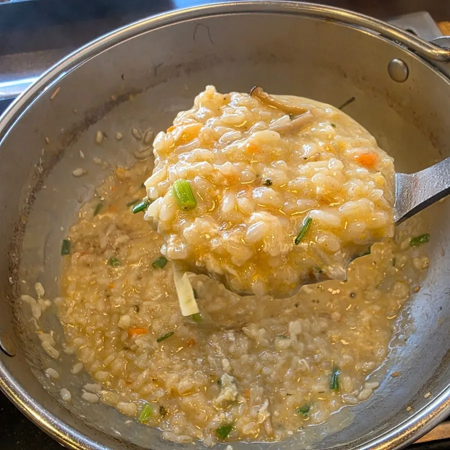 Porridge cooking in the leftover broth