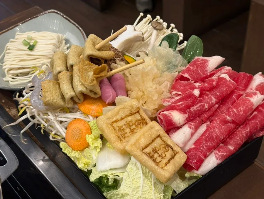 Full spread of shabu-shabu ingredients set on the table