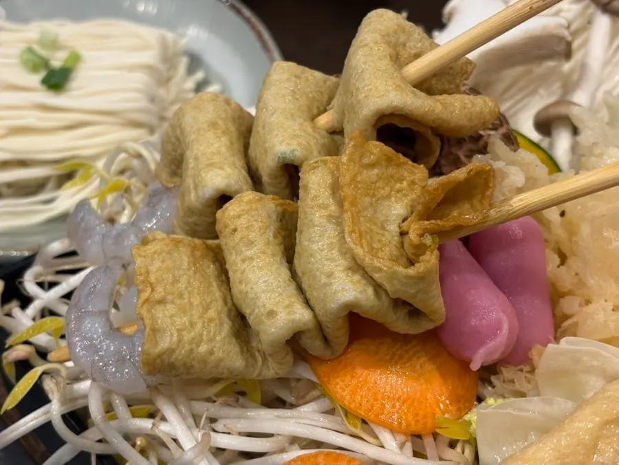 Adding fish cake to the boiling broth