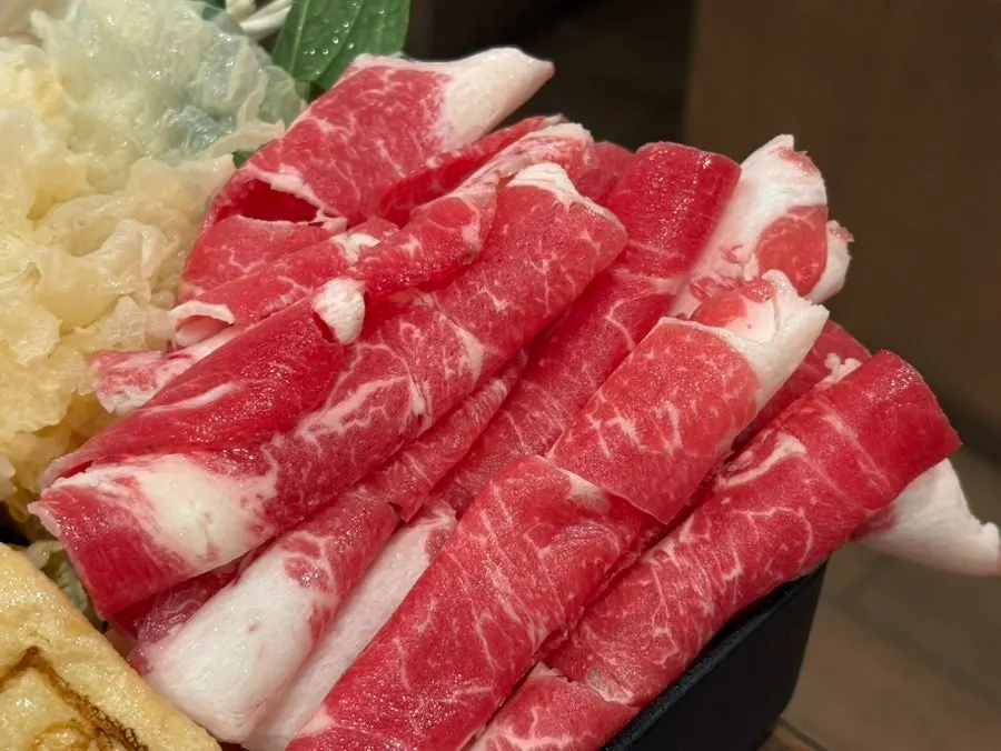 Beef being added to the broth