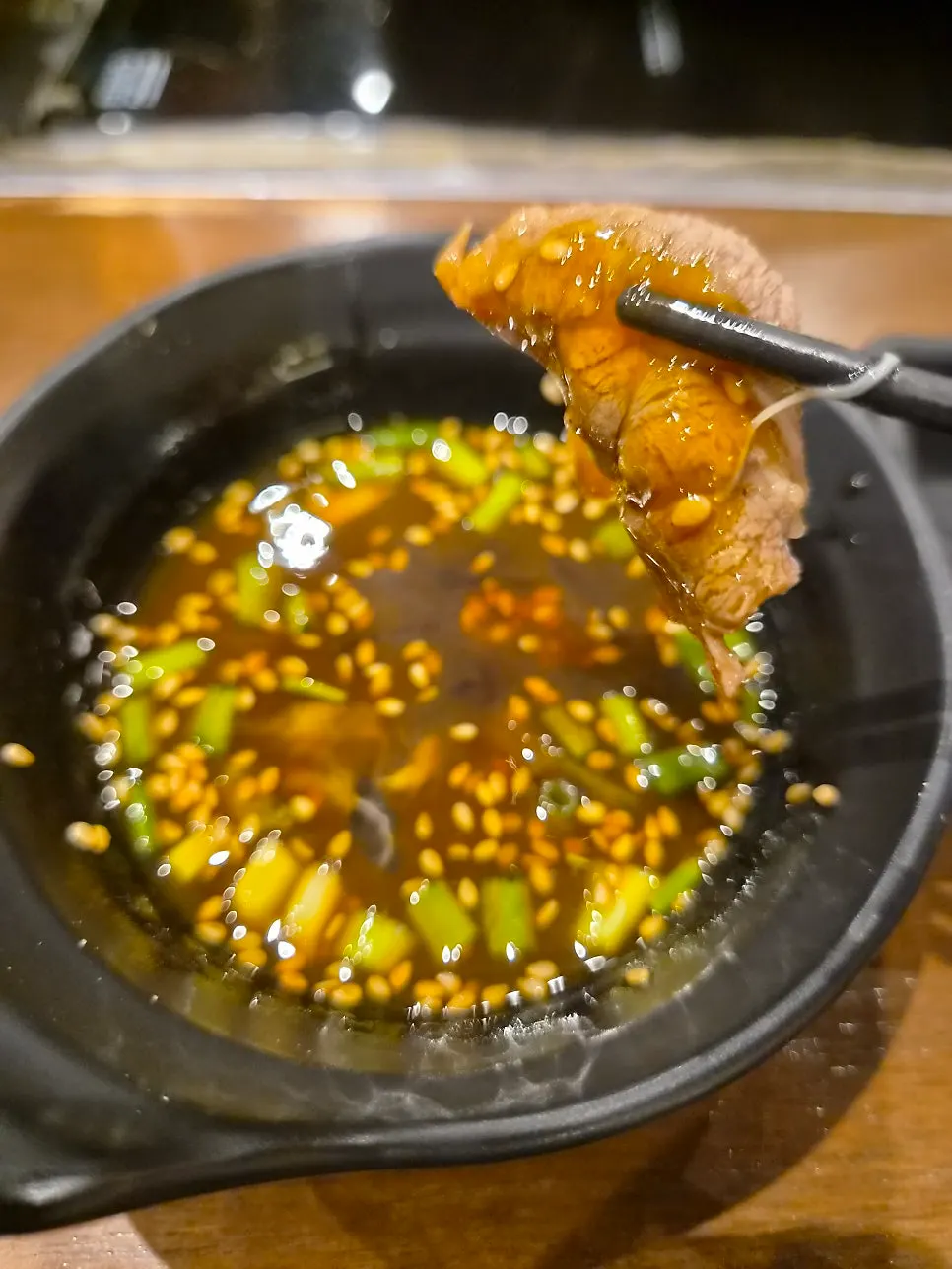 Shabu-shabu pot boiling with ingredients added