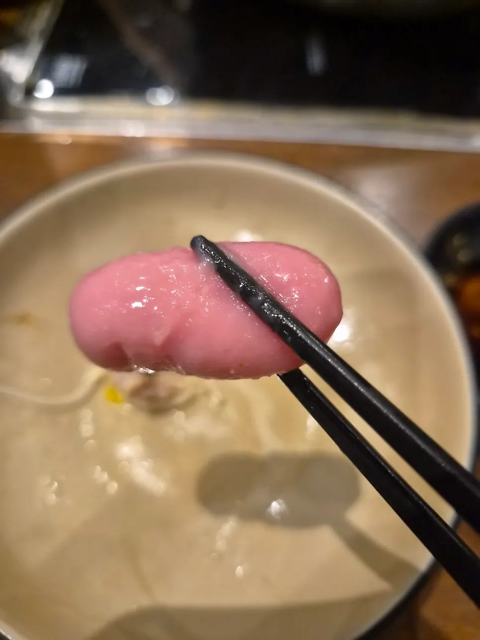 Fish cake skewer dipped in sauce