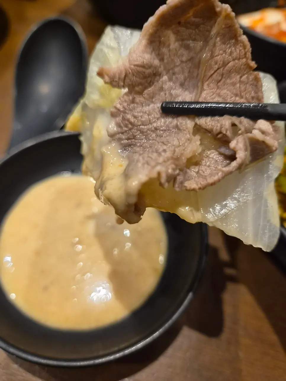 Blanched vegetables and meat dipped in the special sauce