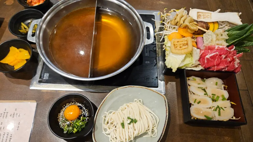Shabu-shabu spread set out with vegetables and mushrooms