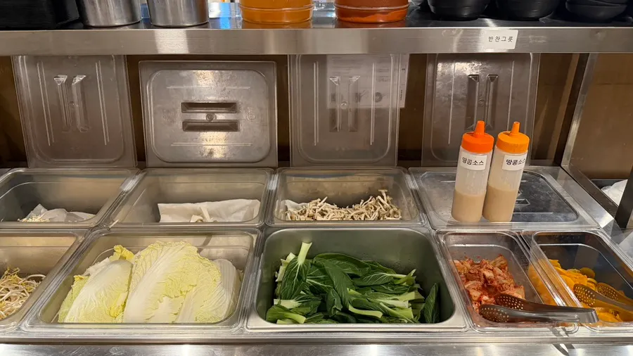 Salad bar filled with mushrooms and vegetables