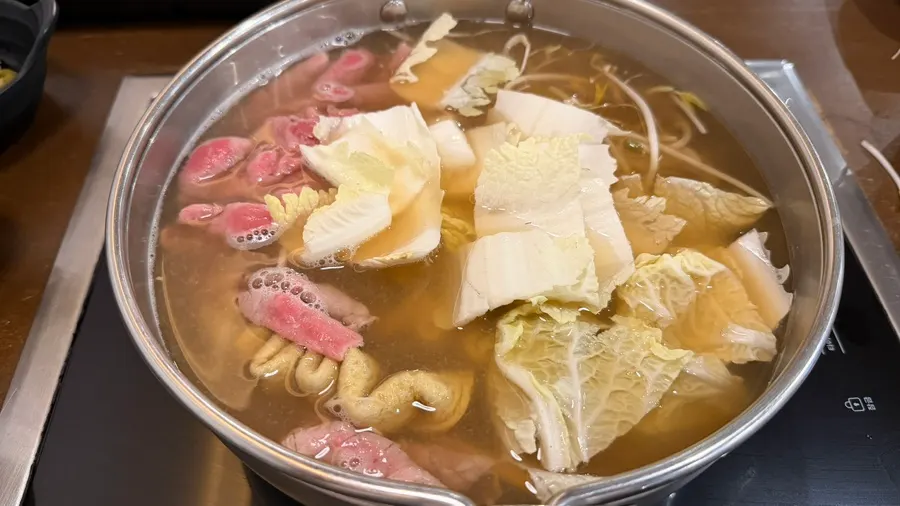 Pot of shabu-shabu simmering with meat and vegetables