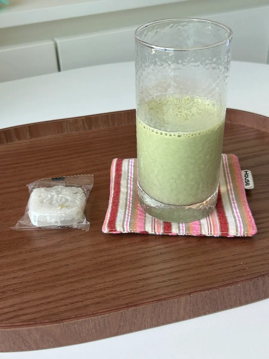 Portable matcha latte sticks next to a finished drink